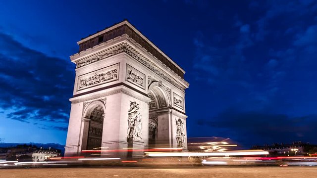 Arc De Triomphe Time-lapse. Low angle street level shot of the Triumphal Arch of the Star on the Champs-Élysées at the center of Place Charles de Gaulle.