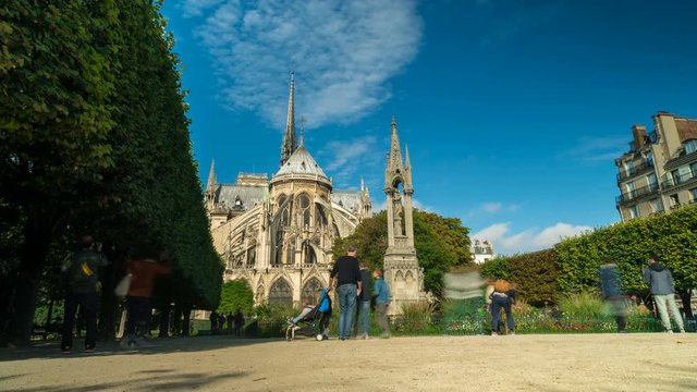 Notre Dame Cathedral Time-lapse. Time-lapse of the Notre-Dame de Paris ("Our Lady of Paris") with clouds in the background and tourists in the foreground.