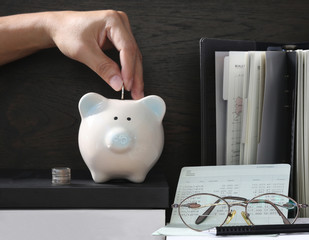 Pig piggy bank, coins, bank book, glasses. The concept of saving money