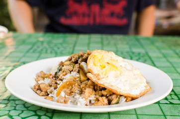 Thai street food,Rice topped fried stir basil with minced pork and fried egg on dish ready to eating