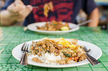 Thai street food,Rice topped fried stir basil with minced pork and fried egg on dish ready to eating