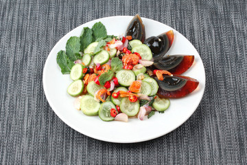 Spicy cucumber salad with dried shrimp and  preserved egg.