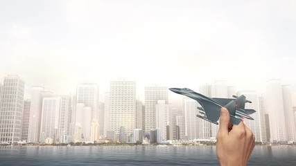 Hand Holding Fighter Jet - City Scene