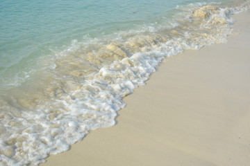 Foamy white waves on the beach