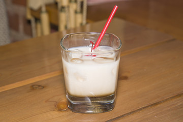 Dairy cocktail in a glass with a cherry.