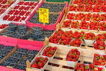 Strawberries, blueberries and raspberries for sale at a market