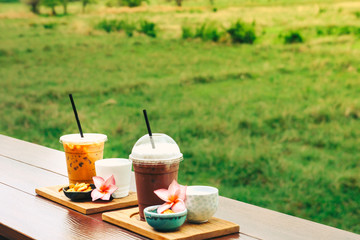 iced coffee and biscuit alphabet with rice field background