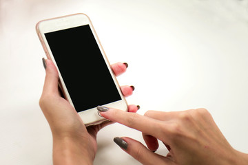 female hand holding the phone similar to iphone with isolated black screen
