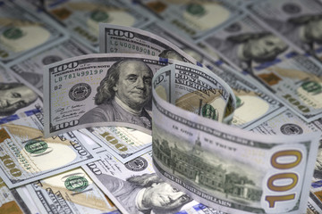 Three hundred us dollar bills standing on hundred us dollar banknotes background. Two banknotes turned by  Benjamin Franklin on the obverse, one by reverse with an image of Independence Hall.