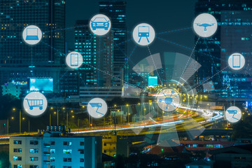 Internet of Things and Smart city concept. Smart things icons mesh on city traffic night background.