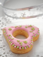 Heart shaped gingerbread glazed with royal icing. Homemade gift cookie. Selective focus on the front.