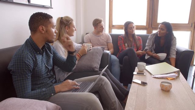 Students Relaxing In Lounge Of Shared Accommodation