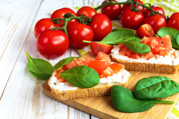 Bruschetta with spinach and cherry tomatoes on toasted baguette