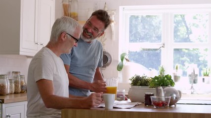 Mature couple having breakfast at home - Powered by Adobe