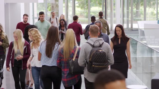 Students and teachers walk in foyer of a modern university, shot on R3D