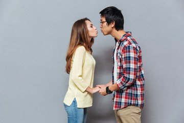 Young attractive interracial couple standing and kissing