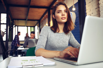 Portrait of a serious businesswoman using laptop in office.