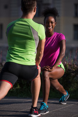 jogging couple warming up and stretching in the city