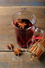 Cup with hot wine on rustic table