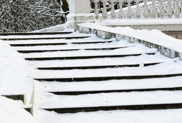 Icy slippery dangerous winter ladder under snow