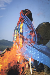 shaman conducts the ceremony near the fire. View through the fire. Authentic photos.