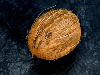 The coconut  on the color of the stone table and dark background
