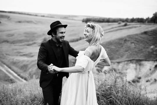 Joyful bride and groom in the lap of the nature