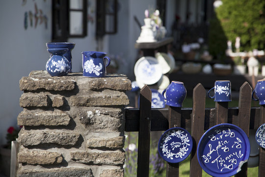 Handmade tableware hung for sale on the fence of a craft shop in the town of Siófok (Hungary), on the shore of Lake Balaton.