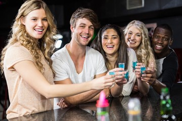 Group of friends having shots