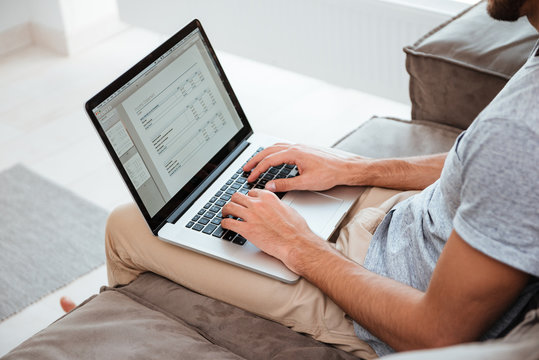 Cropped image of a young man working on his laptop