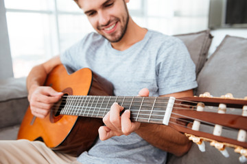 Man playing on guitar in home