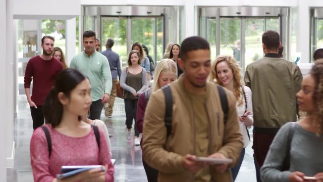 Students walking through the foyer of a modern university, shot on R3D