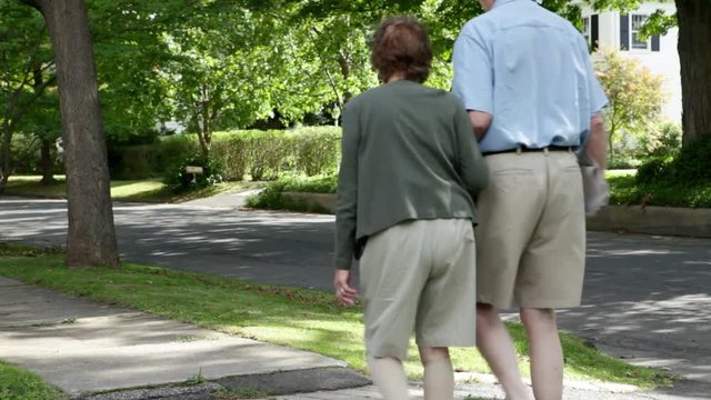 Senior Couple Walking In Neighborhood