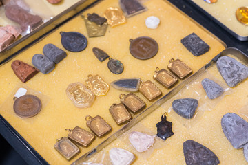 Bangkok, Thailand - famous amulet market with stone and metal Buddhist talismans
