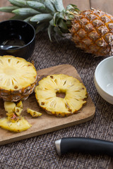 pineapple ftuit and slices on the table.