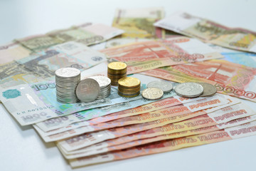 Russian roubles, coin stacks are on the bills