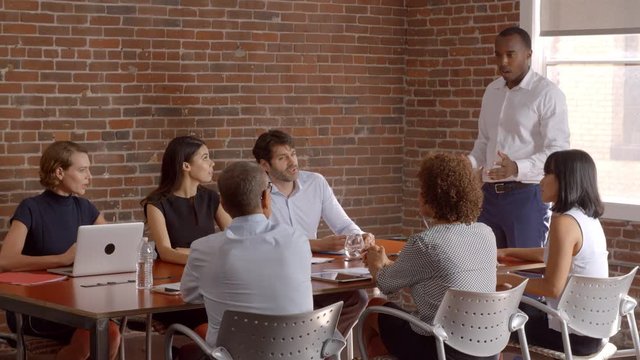 Businessman Standing To Address Boardroom Meeting 
