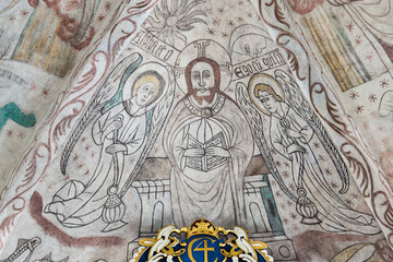 Fototapeta na wymiar Christ in majesty, a gothic fresco in a Danish church. Christ sits on his throne in judgment, Over Draby church, Denmark, Nov 14, 2016
