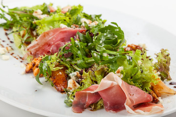 Mixed salad with herbs, prosciutto and parmesan.