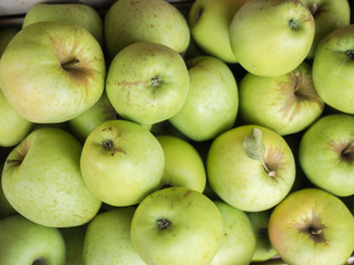 Background of green apples close up. Green apples pattern on sale at the market.