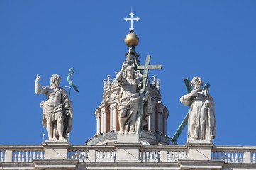 Fototapeta na wymiar Statues on the top of Saint Peter Basilica facade. Rome, Italy