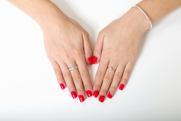 woman's hands with painted nails on a white background