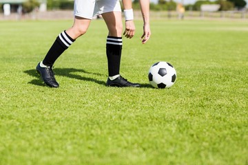 Football player picking up the ball