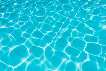Ripple Water in swimming pool with sun reflection