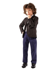 Thoughtful curly boy stands and looks at the camera in a business suit. White background.