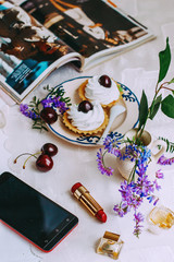 perfume lipstick cupcakes in the background laundy on the table