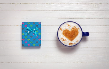 Cup of coffee with heart shape symbol and gift box