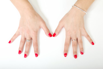 woman's hands with painted nails on a white background