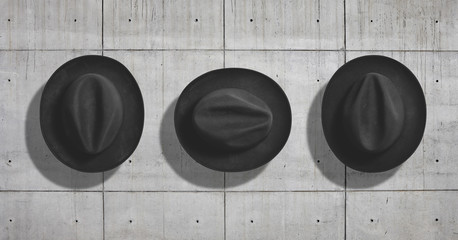 Top view of a classic black felt fedora hat shot as a mockup set on neutral gray concrete industrial background