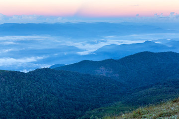 Early morning foggy  sunrise on  top of mountain soft focus grai